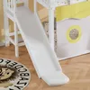 A close-up view of a white bunk bed slide with a yellow and white curtain in the background and a lion rug on the floor. Produktbild-Vorschau