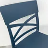 Close-up of the back of a dark blue chair with a decorative criss-cross pattern. Voir les images du produit