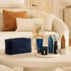 A collection of Rituals products arranged on a coffee table in a living room setting. Produktbild-Vorschau