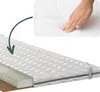 A hand pressing down on a mattress topper, with a cutaway view showing the layers of the mattress. Produktbild-Vorschau