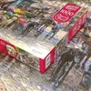 A close-up of a jigsaw puzzle box, with the puzzle itself partially visible in the foreground. Podgląd zdjęcia produktu