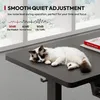 A cat sleeping on a black desk in front of a window. Voir les images du produit