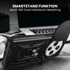 A black smartphone case with a ring stand is shown in a close-up shot, with a laptop and headphones in the background. Produktbild-Vorschau