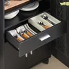 A close-up view of an open kitchen drawer containing cutlery and a bottle opener. Anteprima dell’immagine prodotto