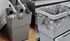 A split image showing two views of a light gray waste bin. The left side shows the bin with two plastic bottles inside and a handle. The right side shows the bin with a trash bag lining it, placed next to another bin. Produktbild-Vorschau