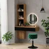 A modern vanity table with a mirror and shelves, decorated with plants and makeup, in a room setting. Podgląd zdjęcia produktu