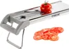 A Stoneline stainless steel vegetable slicer with a tomato on top and sliced tomatoes in front. Produktbild-Vorschau