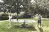 A man and a woman playing table tennis in a garden. Produktbild-Vorschau