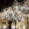 A street decorated with many white LED lights on trees, creating a festive atmosphere. Náhled obrázku produktu