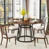 A round dining table with chairs set in a dining room with large windows. Náhľad obrázku produktu