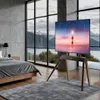 A modern bedroom with a large window overlooking mountains, featuring a TV stand with a TV displaying a scenic image. Podgląd zdjęcia produktu