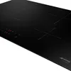 A close-up, angled view of a black induction hob with illuminated controls. Voir les images du produit