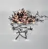 A pile of white LED string lights on a white and gray surface. Produktbild-Vorschau
