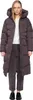 A woman wearing a long puffer coat and trousers, standing against a white background. Produktbild-Vorschau