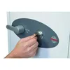 A hand is inserting a key into the lock of a safe. Voir les images du produit
