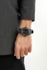 A person wearing a watch on their wrist. Produktbild-Vorschau