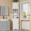 A bathroom scene with a white storage cabinet, a gray vanity with a sink, and a window. Náhled obrázku produktu