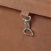 A close-up view of a metal clasp attached to a brown fabric material. Produktbild-Vorschau
