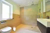 A modern bathroom with a toilet, shower, and sink. Produktbild-Vorschau