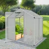 A greenhouse with plants inside, set in a garden. Produktbild-Vorschau