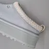 Close-up view of the heel and sole of a light blue UGG slipper. Produktbild-Vorschau
