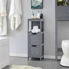 A bathroom scene with a gray storage cabinet, towels, and a toilet. Produktbild-Vorschau