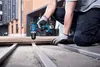 A person is using a Bosch drill to screw a piece of wood into a metal frame outdoors. Náhled obrázku produktu