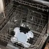 Glass food containers with plastic lids are stacked inside a dishwasher. Náhled obrázku produktu