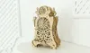 A wooden pendulum clock model is displayed on a white table against a white background. Voir les images du produit