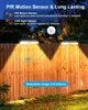 Solar lights mounted on a wooden fence at night, with light beams illuminating the fence and surrounding area. Produktbild-Vorschau