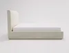 A side view of a cream-colored upholstered bed frame with a mattress on a plain white background. Náhled obrázku produktu