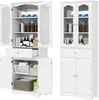 Two white storage cabinets are shown side-by-side against a white background. The cabinet on the left is open, revealing its contents and shelves. The cabinet on the right is closed, showing its glass doors and drawers. Podgląd zdjęcia produktu