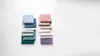 Two stacks of folded fabric swatches, one in shades of blue and green, the other in shades of pink and purple, arranged on a white background. Náhľad obrázku produktu