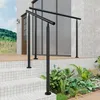 A black metal handrail installed on outdoor stairs leading to a house entrance. Produktbild-Vorschau