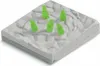 A toy playset with a rocky terrain and several green crystal-like figures. Produktbild-Vorschau