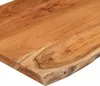 A close-up shot of a wooden countertop with a live edge. Voir les images du produit