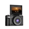 A black digital camera with its screen flipped up, showing a sunset scene. Produktbild-Vorschau