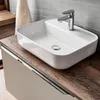 A modern bathroom vanity with a white ceramic sink and a chrome faucet. Produktbild-Vorschau
