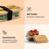 Collage of images showing a glass food container with a bamboo lid and cutlery, and another container with berries and blueberries. Produktbild-Vorschau
