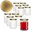 A collection of glass jars with gold lids, one filled with red liquid. Podgląd zdjęcia produktu