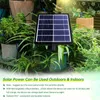 A solar panel is shown in a garden setting with plants and pots. Produktbild-Vorschau