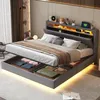 A modern bedroom with a grey upholstered bed featuring built-in storage and LED lighting.