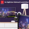 A marketing image showing a TV with a city skyline, and a small device attached to the back of another TV, with text overlays. Produktbild-Vorschau