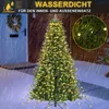 A Christmas tree decorated with lights, standing outside in the rain. Produktbild-Vorschau