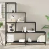 A black, multi-tiered bookshelf filled with decorative items and books. Náhled obrázku produktu