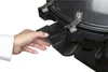 A hand is shown interacting with a black plastic component of an electric grill. Produktbild-Vorschau