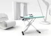 A modern, minimalist room with a white rocking chair, an ironing board with an iron, and sheer curtains. Produktbild-Vorschau