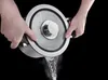 Hands holding a pot and pouring water out of it. Produktbild-Vorschau