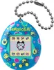 A close-up studio shot of a blue Tamagotchi with a floral pattern and a digital screen displaying a pixelated character. Náhled obrázku produktu