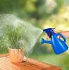 A hand sprays water onto a potted plant from a blue watering can. Produktbild-Vorschau